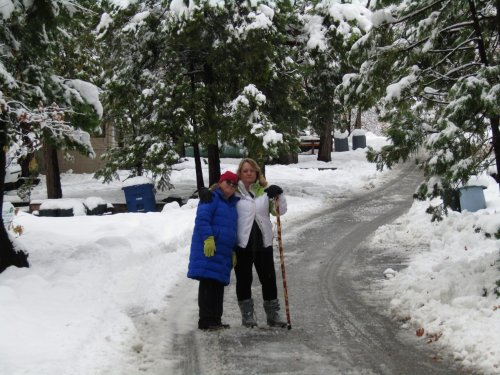 girls in snow on road